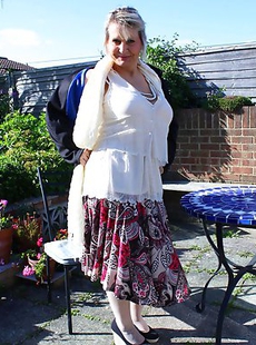 Busty mature lady strips in her garden